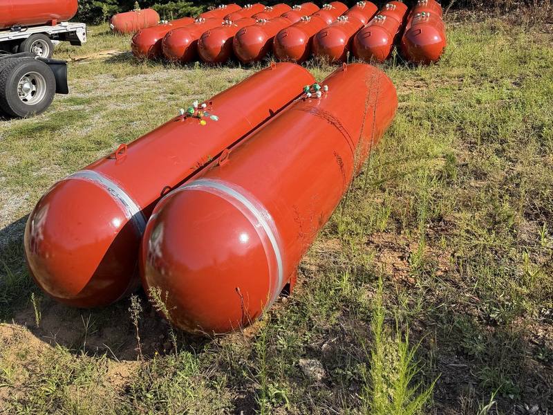 Two 1000 gallon propane tanks with a row of 500 gallon tanks behind them at the yard