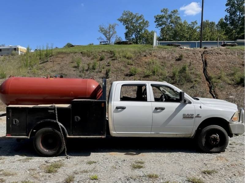 A customer's service truck leaving the yard with a 500 gallon propane tank on the bed