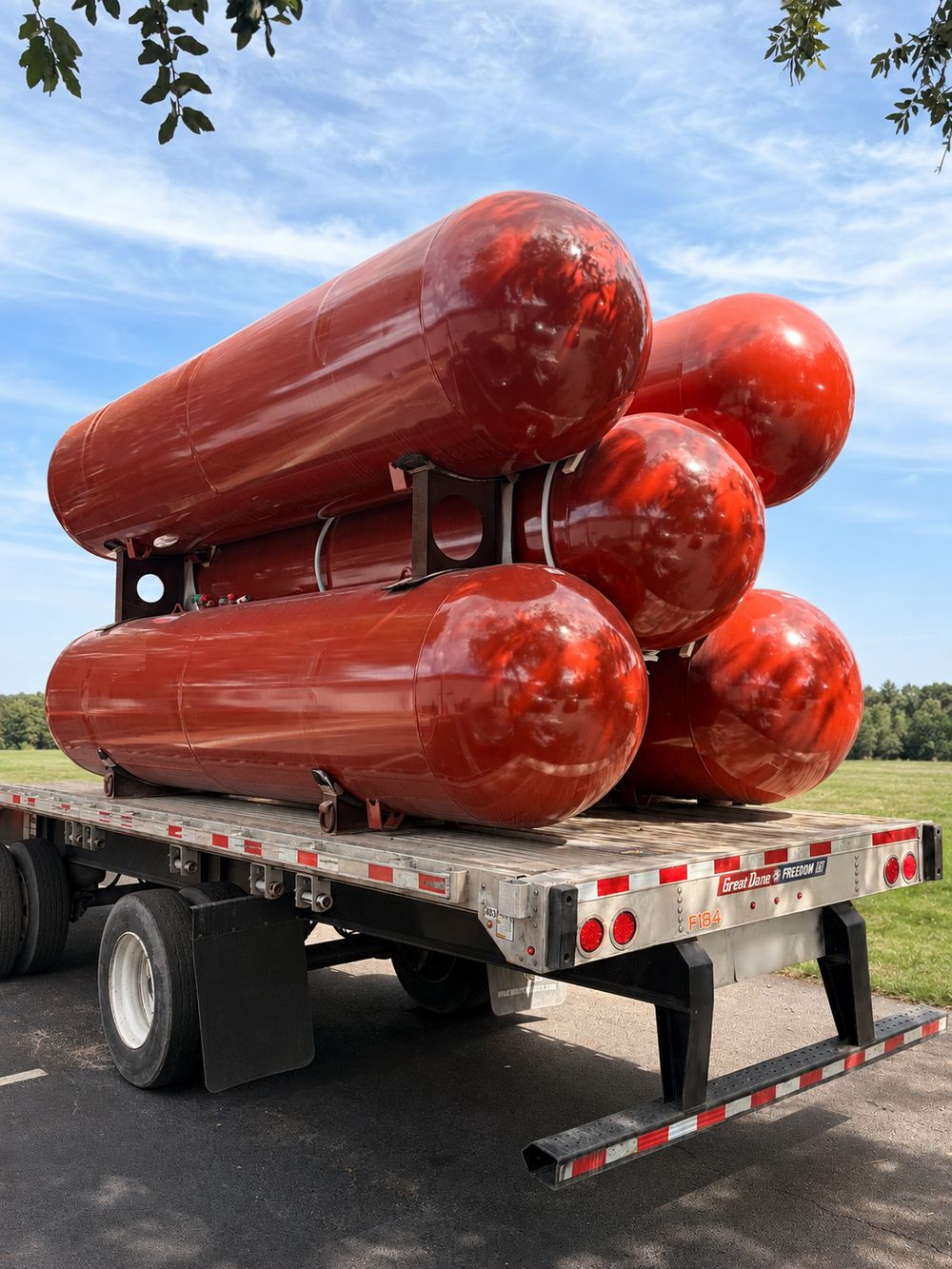 A flatbed trailer loaded with 1000 gallon propane tanks
